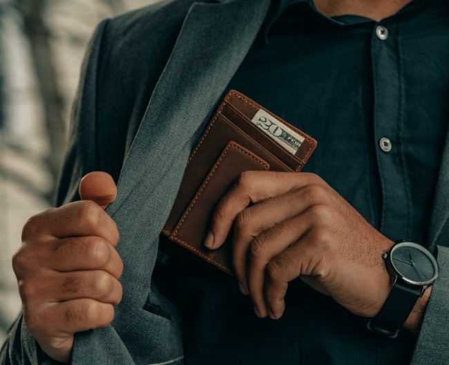 Untitled design (23) man holding wallet